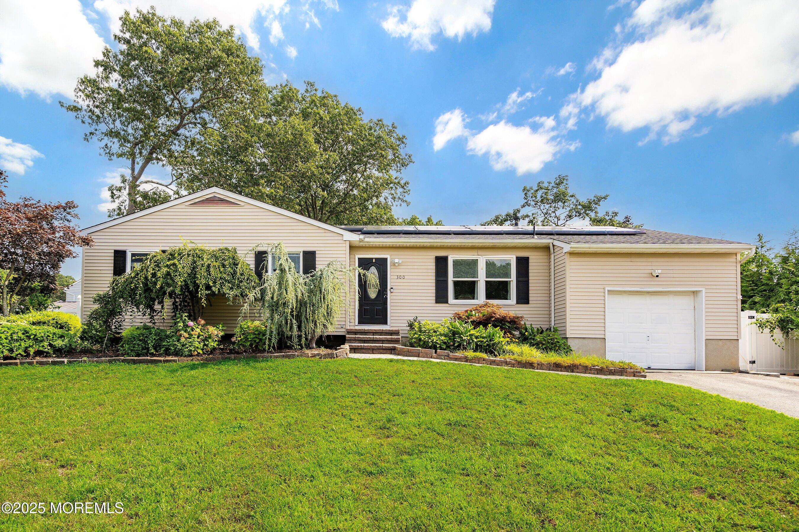 a front view of house with yard and green space