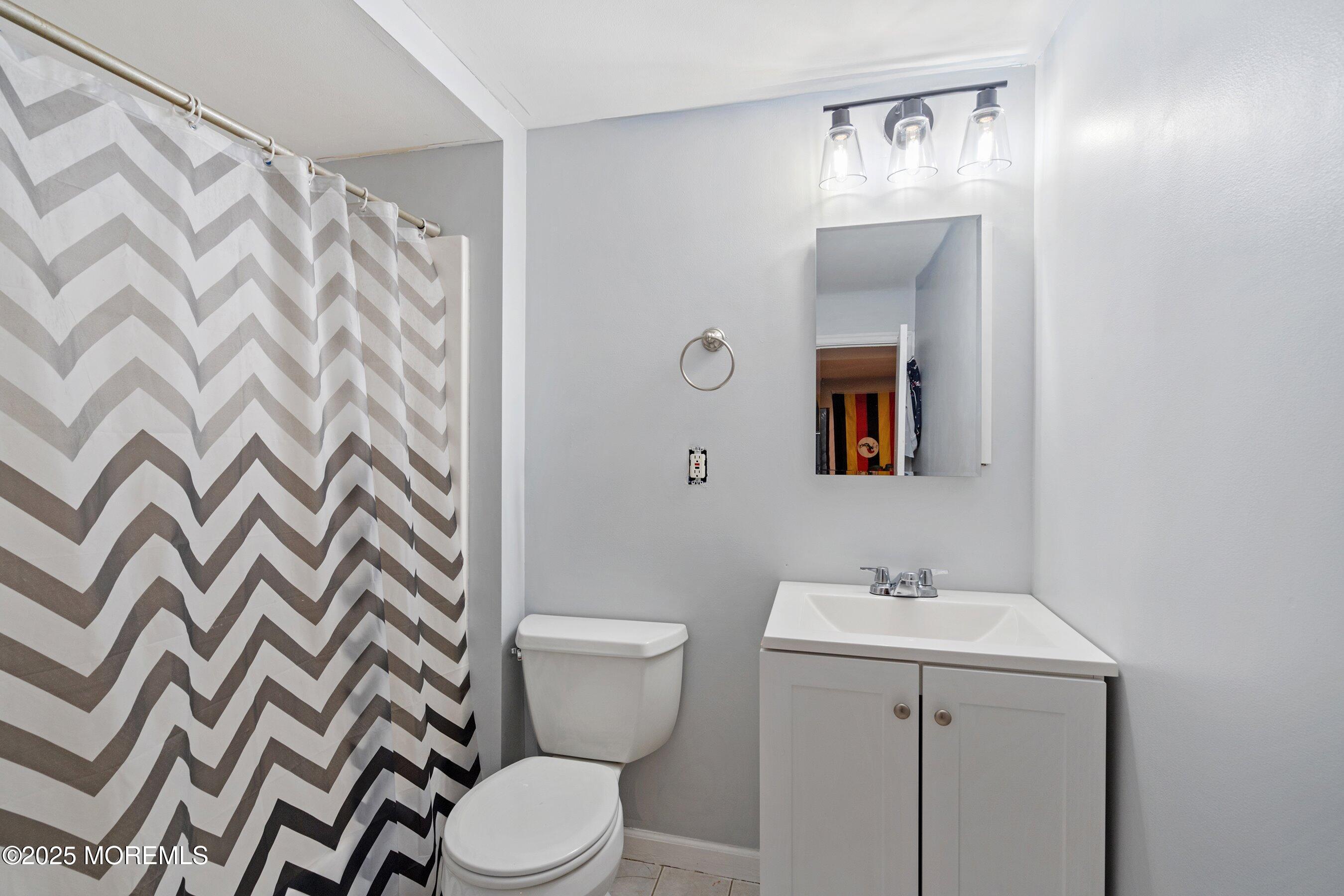 300 Bellanca Road Brick, NJ 08723 - Photo 20 of 23 a bathroom with a sink and mirror with toilet