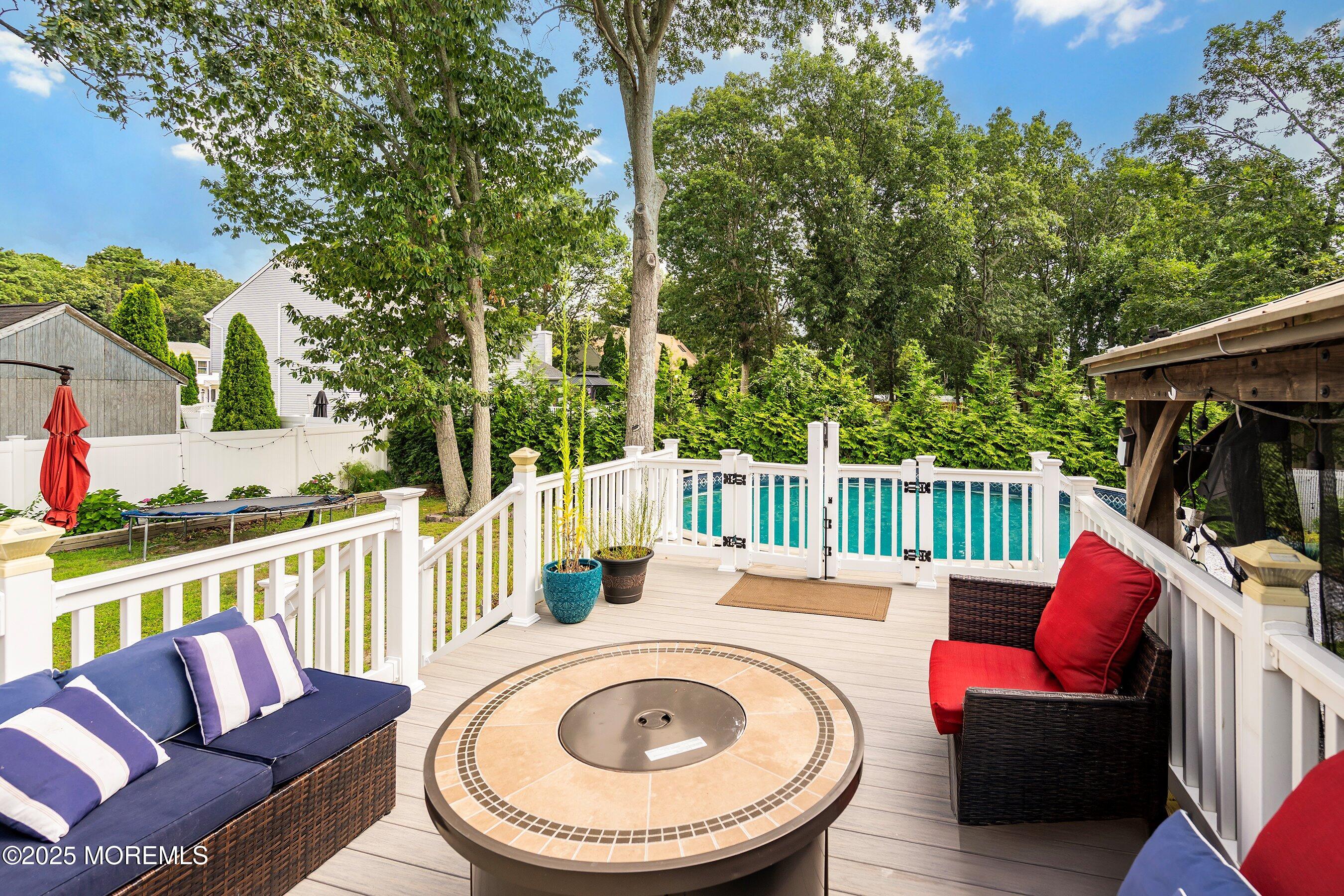 300 Bellanca Road Brick, NJ 08723 - Photo 21 of 23 a view of a deck with furniture and a fire pit