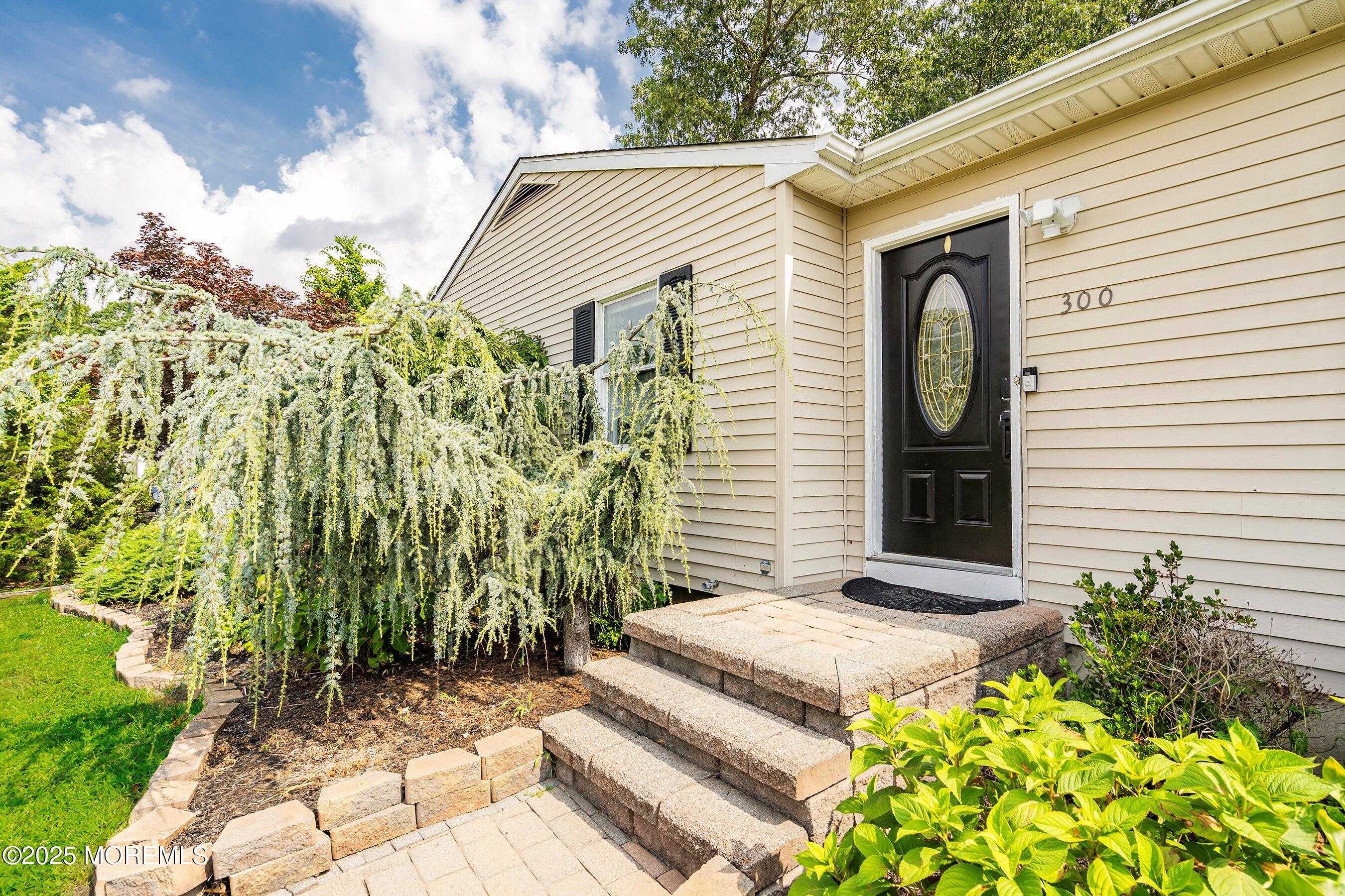 300 Bellanca Road Brick, NJ 08723 - Photo 3 of 23 a view of a white house with a small yard and plants