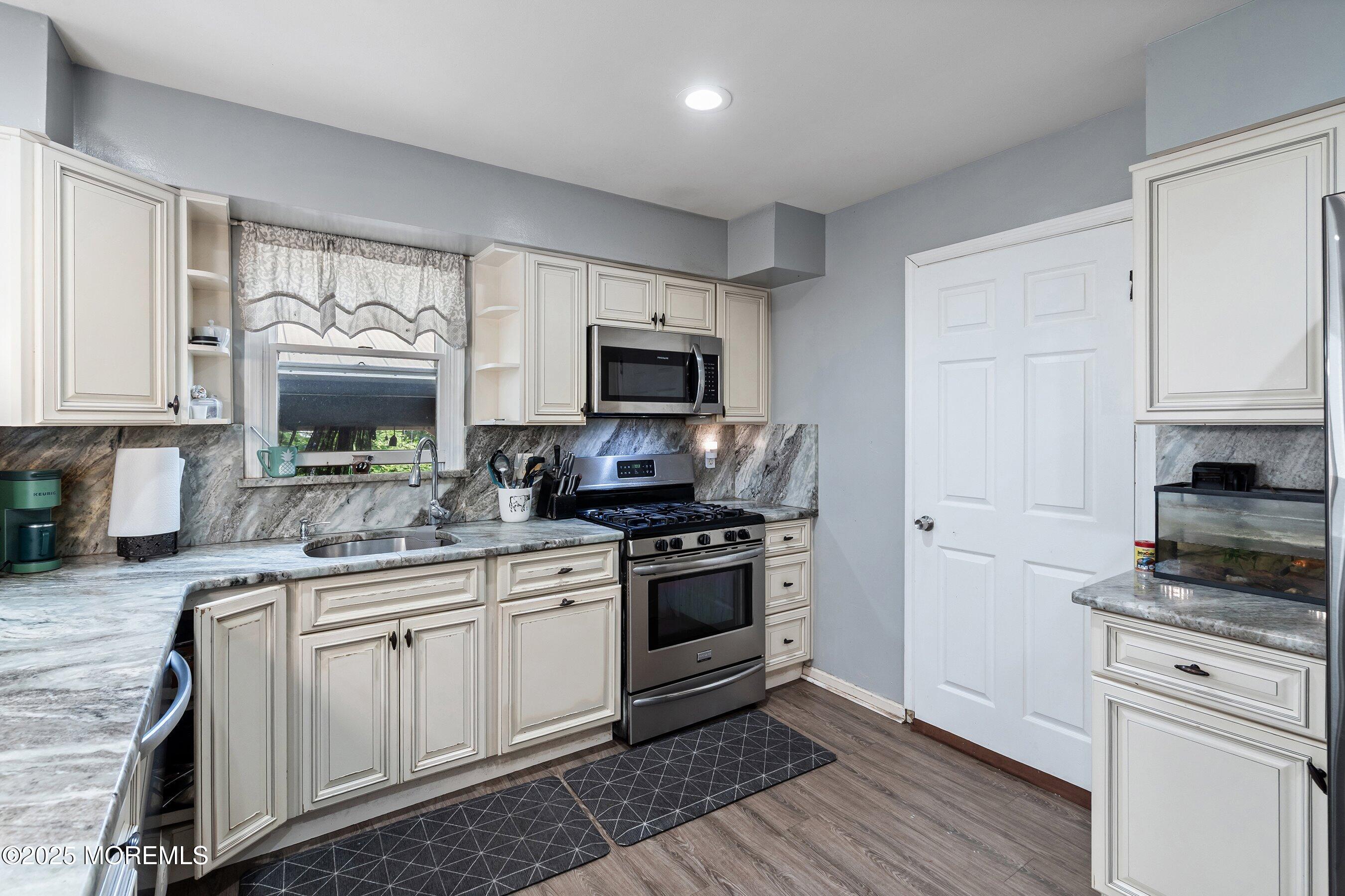 300 Bellanca Road Brick, NJ 08723 - Photo 7 of 23 a kitchen with a sink stove and microwave
