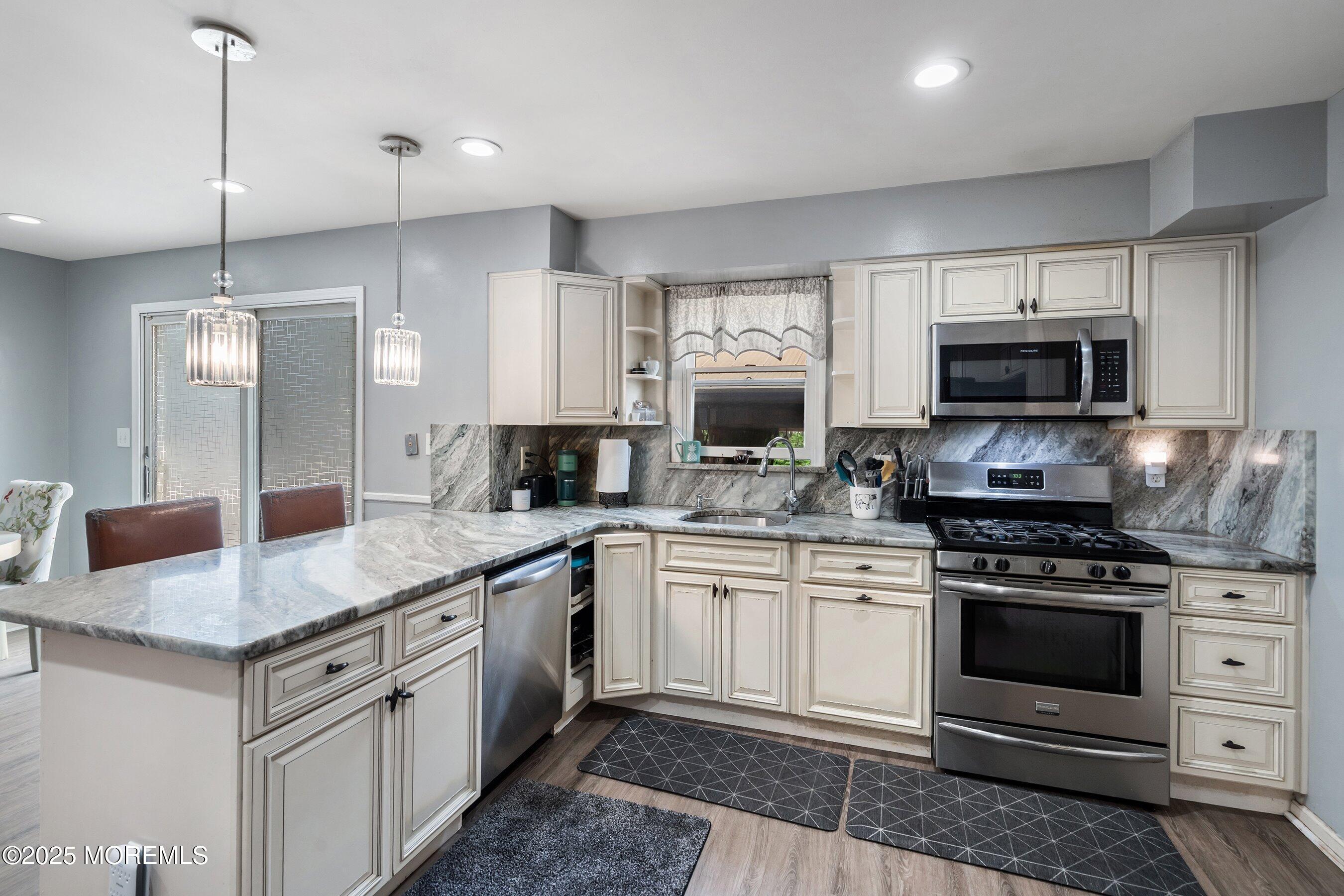 300 Bellanca Road Brick, NJ 08723 - Photo 8 of 23 a kitchen with stainless steel appliances granite countertop a stove a sink and a microwave