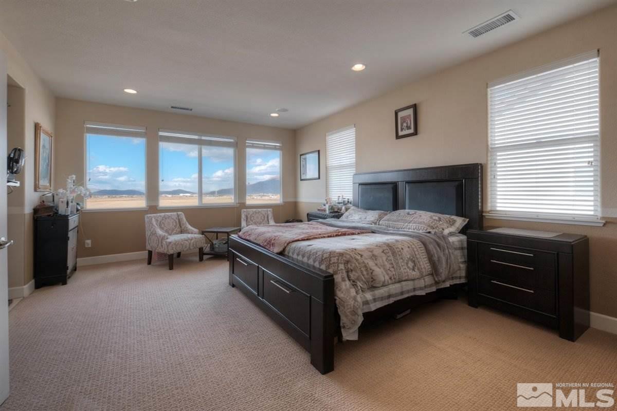 425 Manciano Way Reno, NV 89521 - Photo 13 of 28 a bedroom with a bed and a couch
