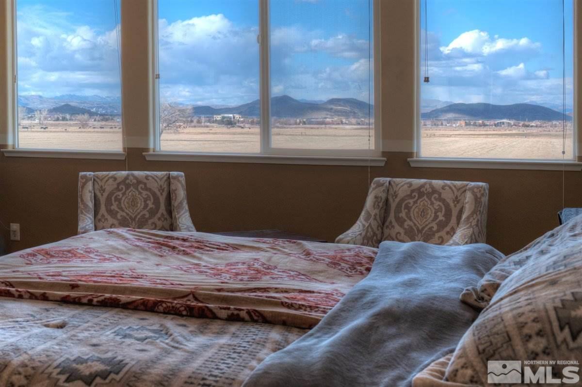 425 Manciano Way Reno, NV 89521 - Photo 14 of 28 a bed sitting in a bedroom next to a window