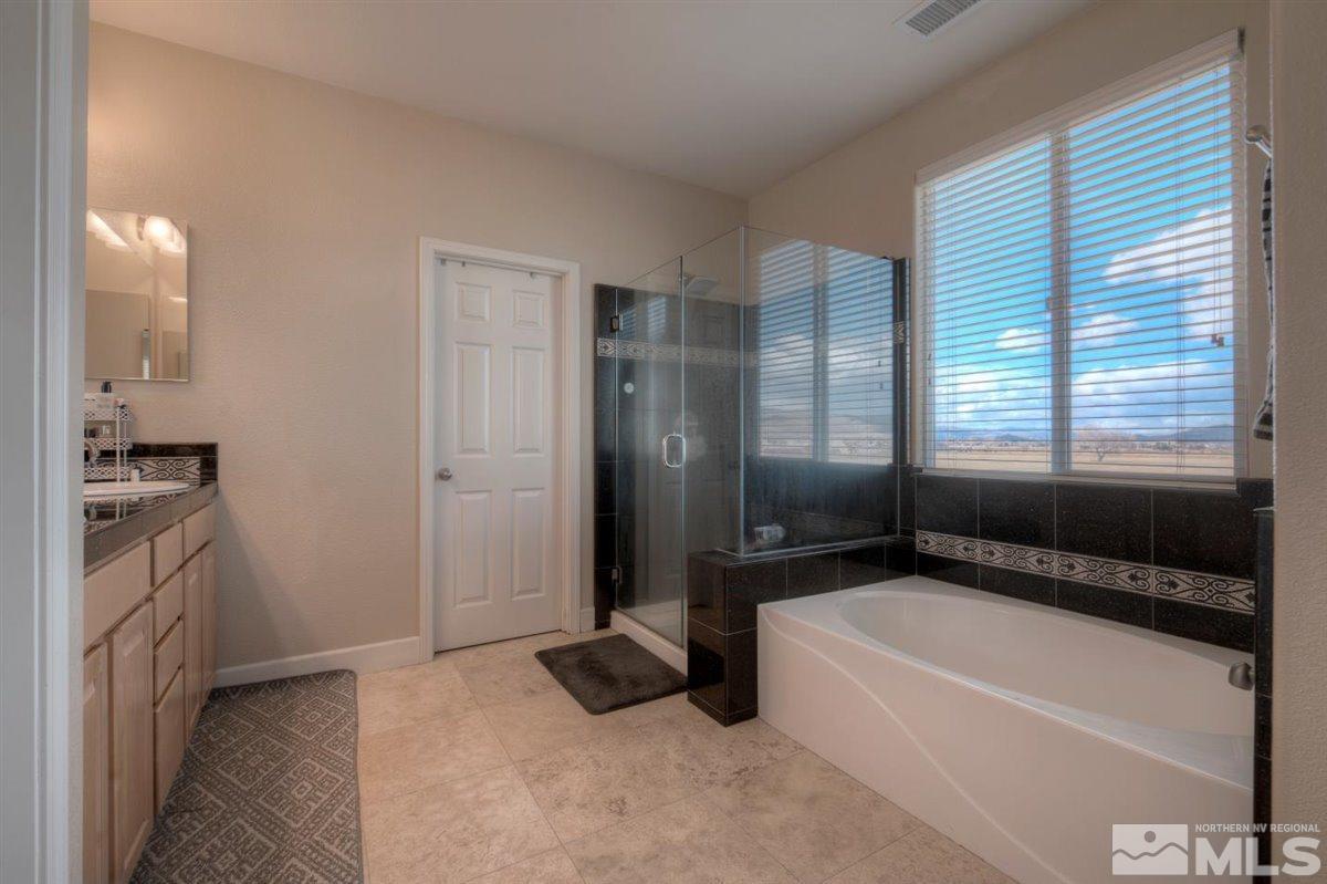 425 Manciano Way Reno, NV 89521 - Photo 16 of 28 a bathroom with a bathtub and a shower