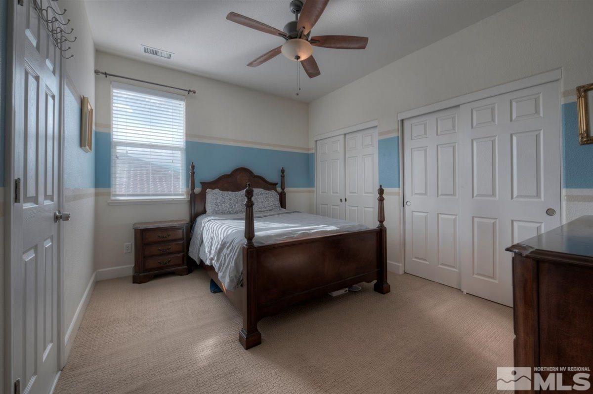 425 Manciano Way Reno, NV 89521 - Photo 18 of 28 a bed sitting in a bedroom next to a window