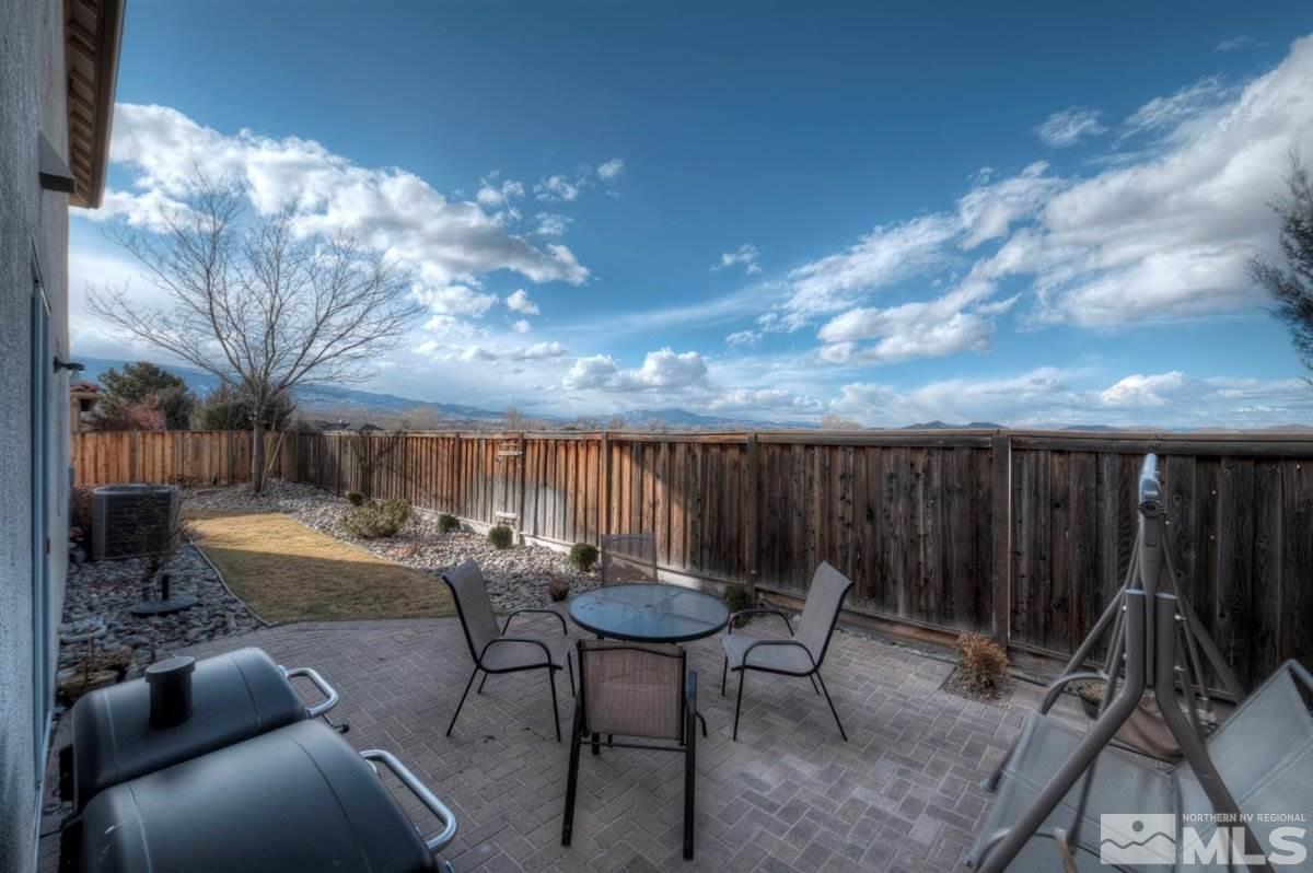 425 Manciano Way Reno, NV 89521 - Photo 23 of 28 a backyard of a house with table and chairs