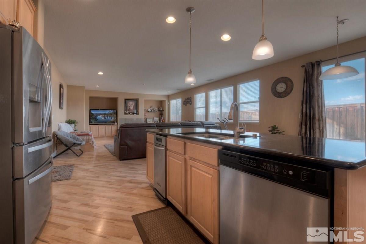 425 Manciano Way Reno, NV 89521 - Photo 8 of 28 a kitchen with stainless steel appliances granite countertop counter space a sink and a refrigerator