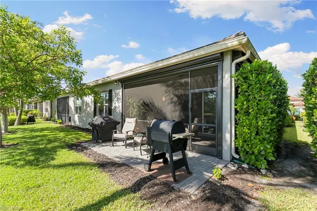 a view of a backyard with sitting area and garden