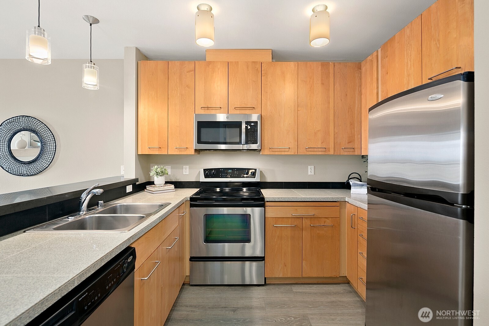 655 Crockett Street, Unit A204 Seattle, WA 98109 - Photo 11 of 23 a kitchen with a sink stove and microwave