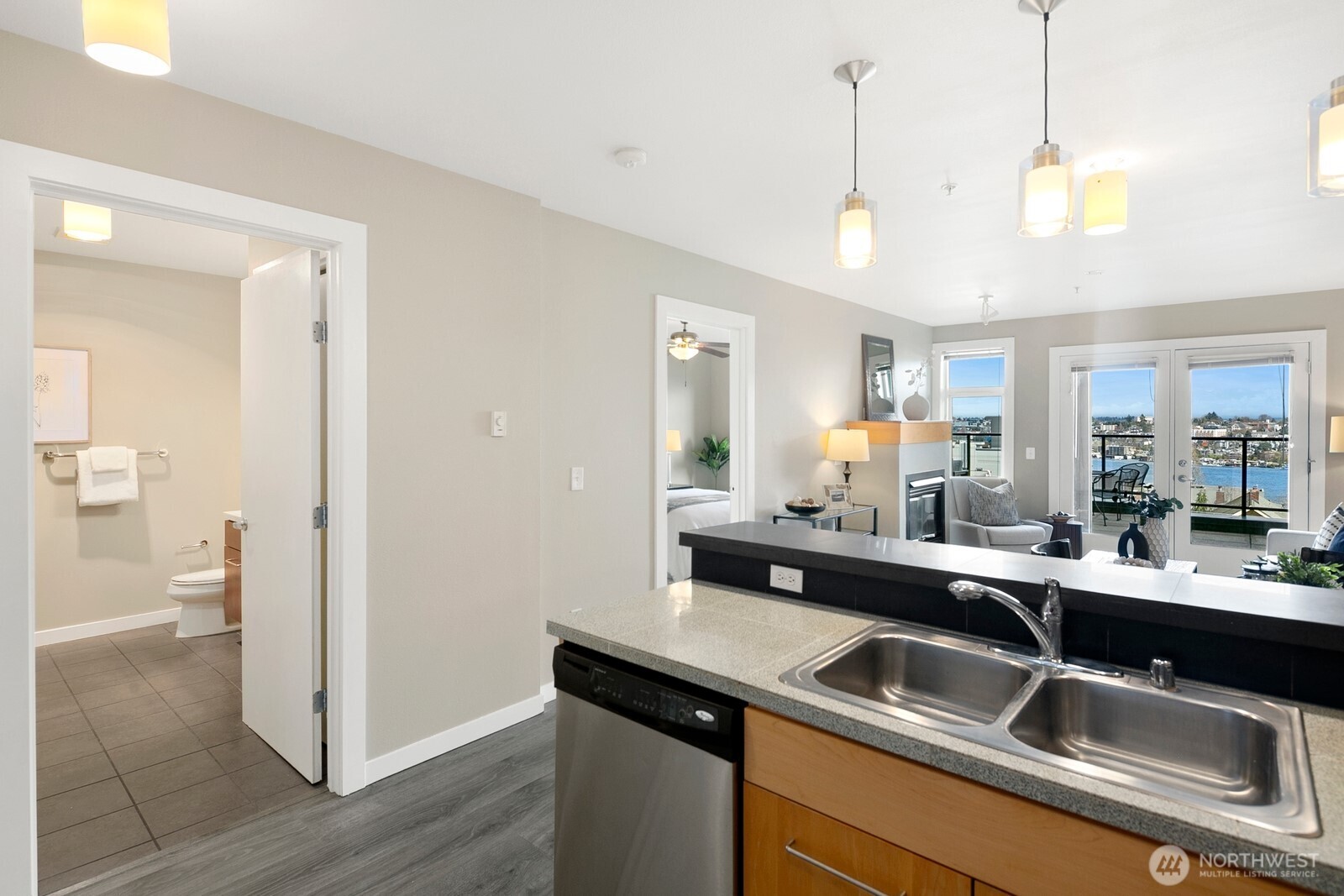 655 Crockett Street, Unit A204 Seattle, WA 98109 - Photo 13 of 23 a kitchen with stainless steel appliances granite countertop a sink and a refrigerator