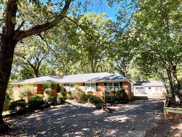 a view of a big house with a tree and outdoor space