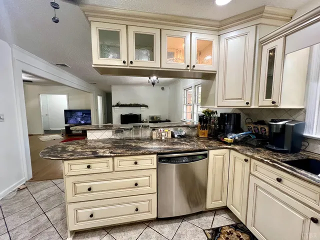 a bathroom with a granite countertop sink toilet and mirror