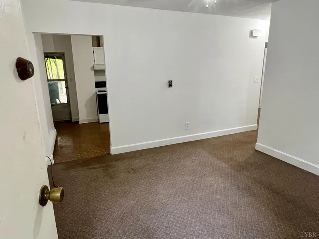 a view of a swimming pool with lawn chairs under an umbrella