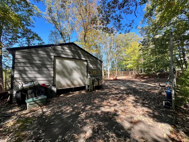 a view of house with backyard outdoor seating and trees