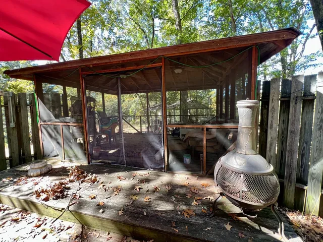 a view of a patio with table and chairs under an umbrella