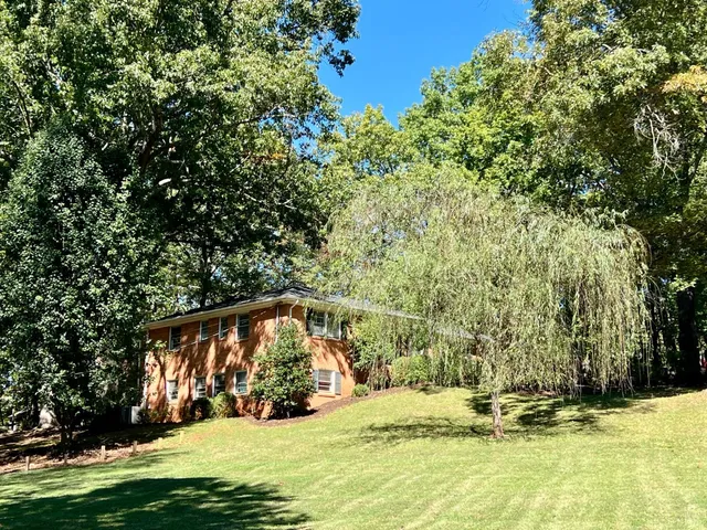 a front view of house with yard and green space