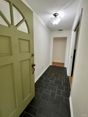 a kitchen with granite countertop a stove a sink and a refrigerator