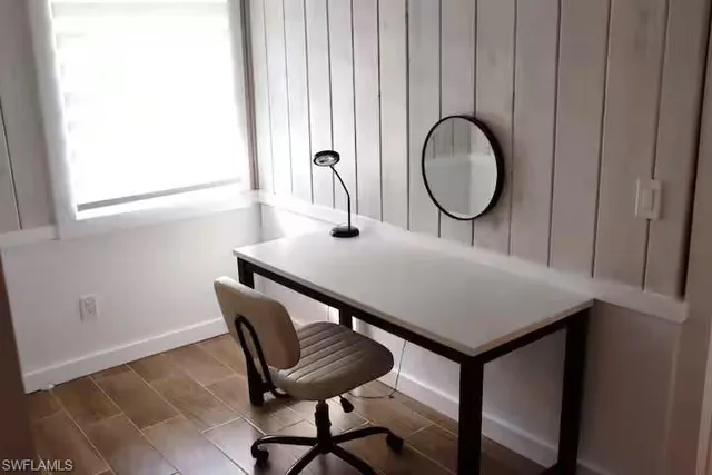 a view of a room with furniture and window