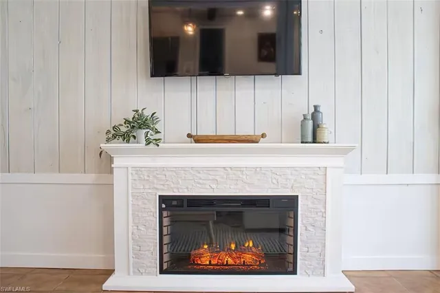 a living room with a fireplace and a wooden floor
