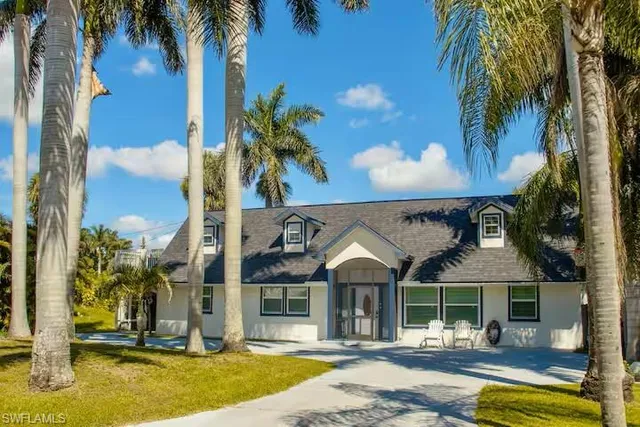 a front view of a house with swimming pool and porch