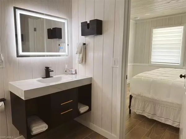 a bathroom with a sink vanity and a mirror
