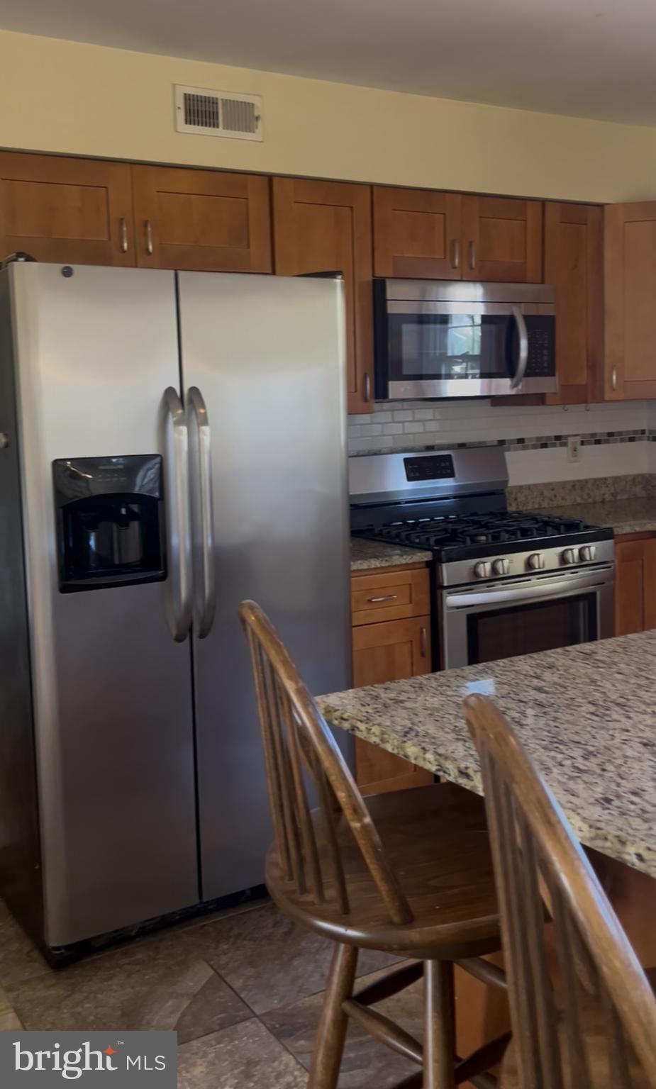 1 Maple Point Drive Langhorne, PA 19047 - Photo 2 of 12 a kitchen with a table and stainless steel appliances