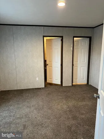 a view of an empty room and a window