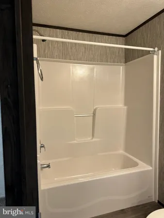 a bathroom with a shower and a bath tub