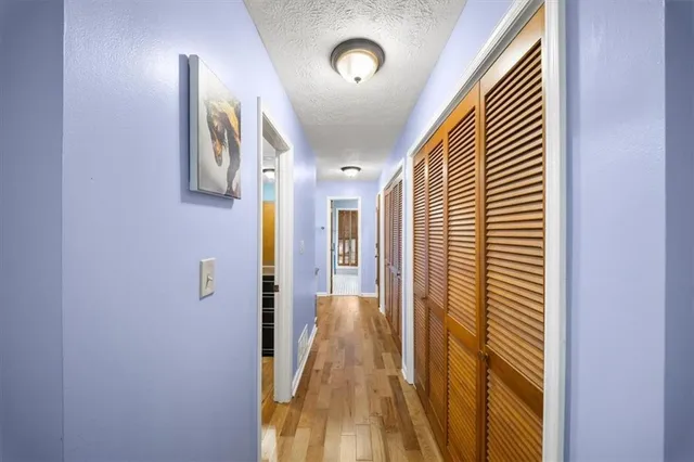 a view of hallway with wooden floor