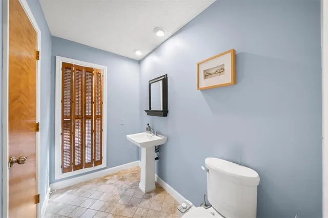 a bathroom with a toilet sink and window