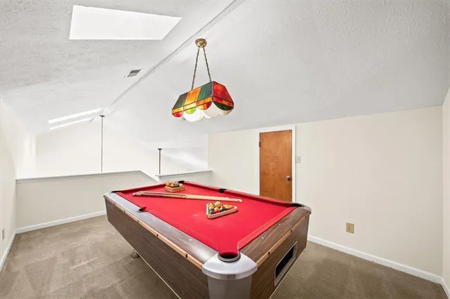 a room with pool table and a chandelier
