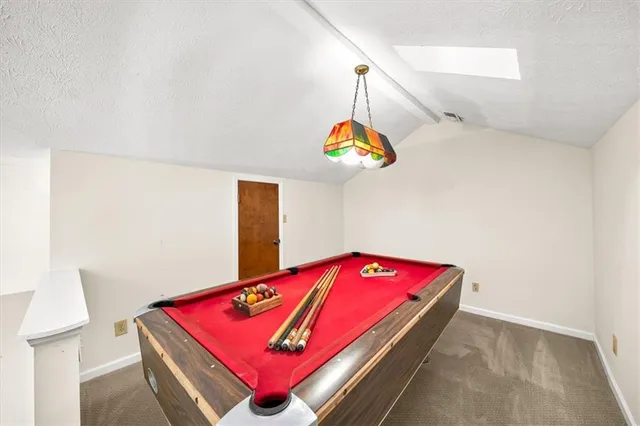 a room with pool table and a chandelier