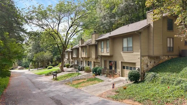 a front view of a house with garden and porch