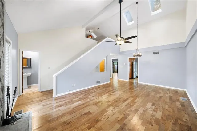 a view of a livingroom with wooden floor and stairs