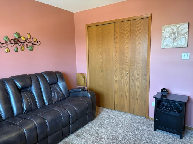 a living room with a couch and a dresser