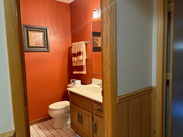 a bathroom with a granite countertop toilet and sink