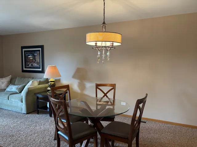 a view of a dining room with furniture and chandelier