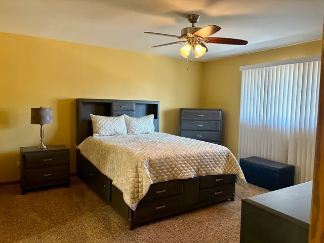 a bedroom with a bed and a table