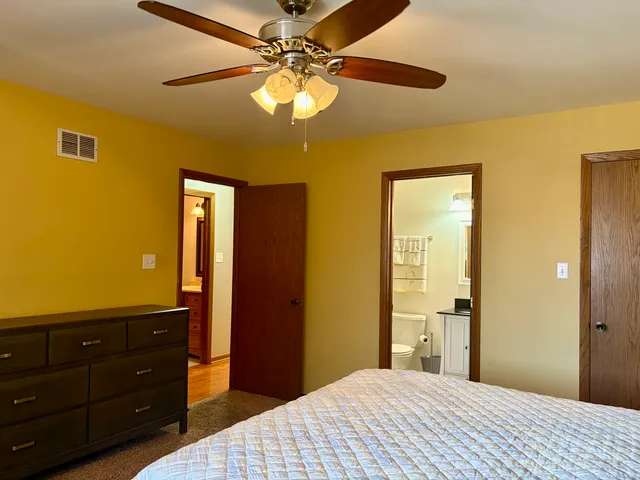 a bedroom with a bed and a dresser