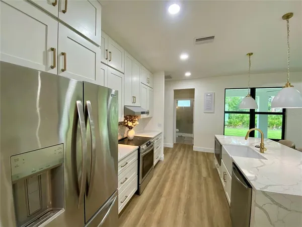 a kitchen with counter top space and stainless steel appliances
