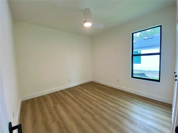 a view of an empty room and wooden floor