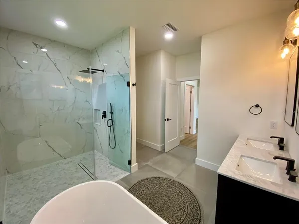a bathroom with a sink toilet and shower