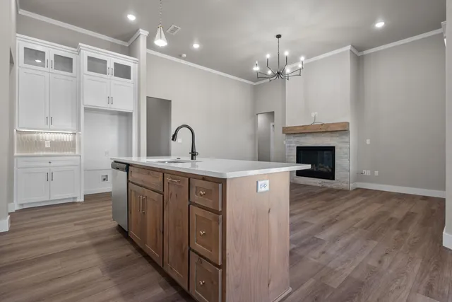 a kitchen with stainless steel appliances a refrigerator sink and stove