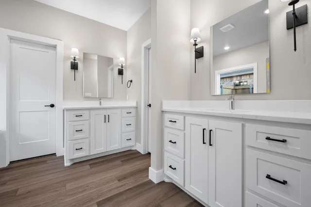 a bathroom with a bathtub sink and mirror