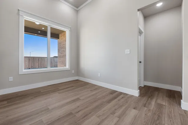 a view of a kitchen with a refrigerator and a stove top oven