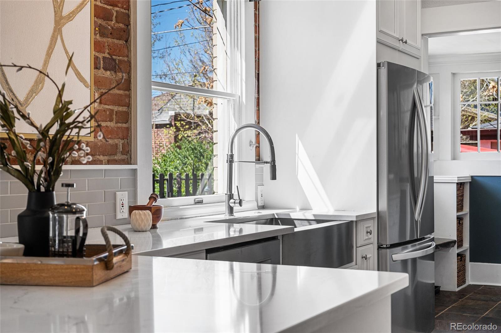 1065 Jackson Street Denver, CO 80206 - Photo 16 of 50 a kitchen with a refrigerator and a sink