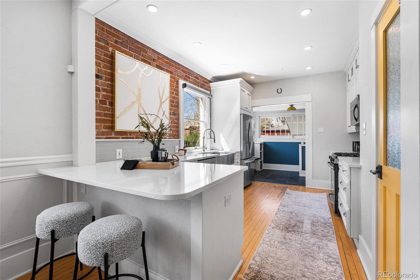 1065 Jackson Street Denver, CO 80206 - Photo 17 of 50 a dining hall with stainless steel appliances granite countertop a sink and a refrigerator