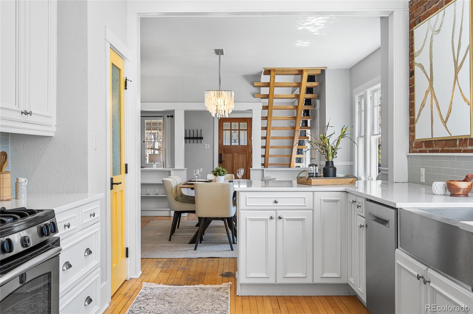 1065 Jackson Street Denver, CO 80206 - Photo 18 of 50 a kitchen with stainless steel appliances a stove a sink and a refrigerator