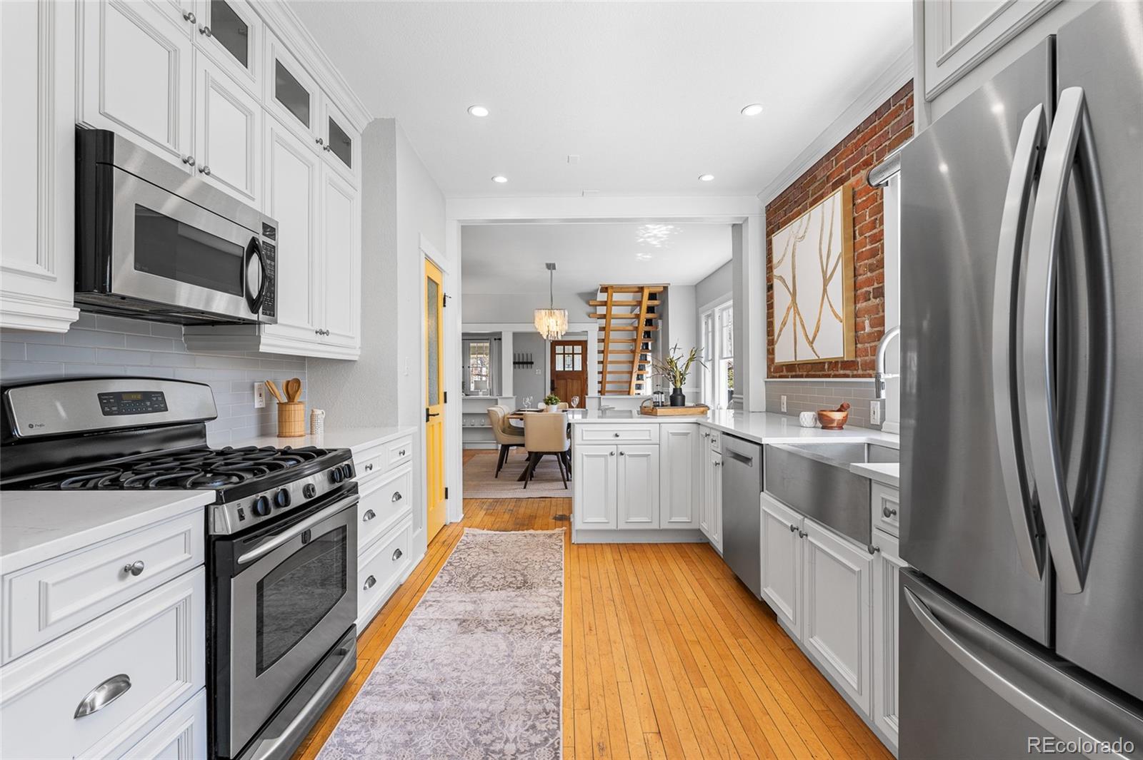 1065 Jackson Street Denver, CO 80206 - Photo 19 of 50 a large kitchen with stainless steel appliances granite countertop a stove a sink and a refrigerator